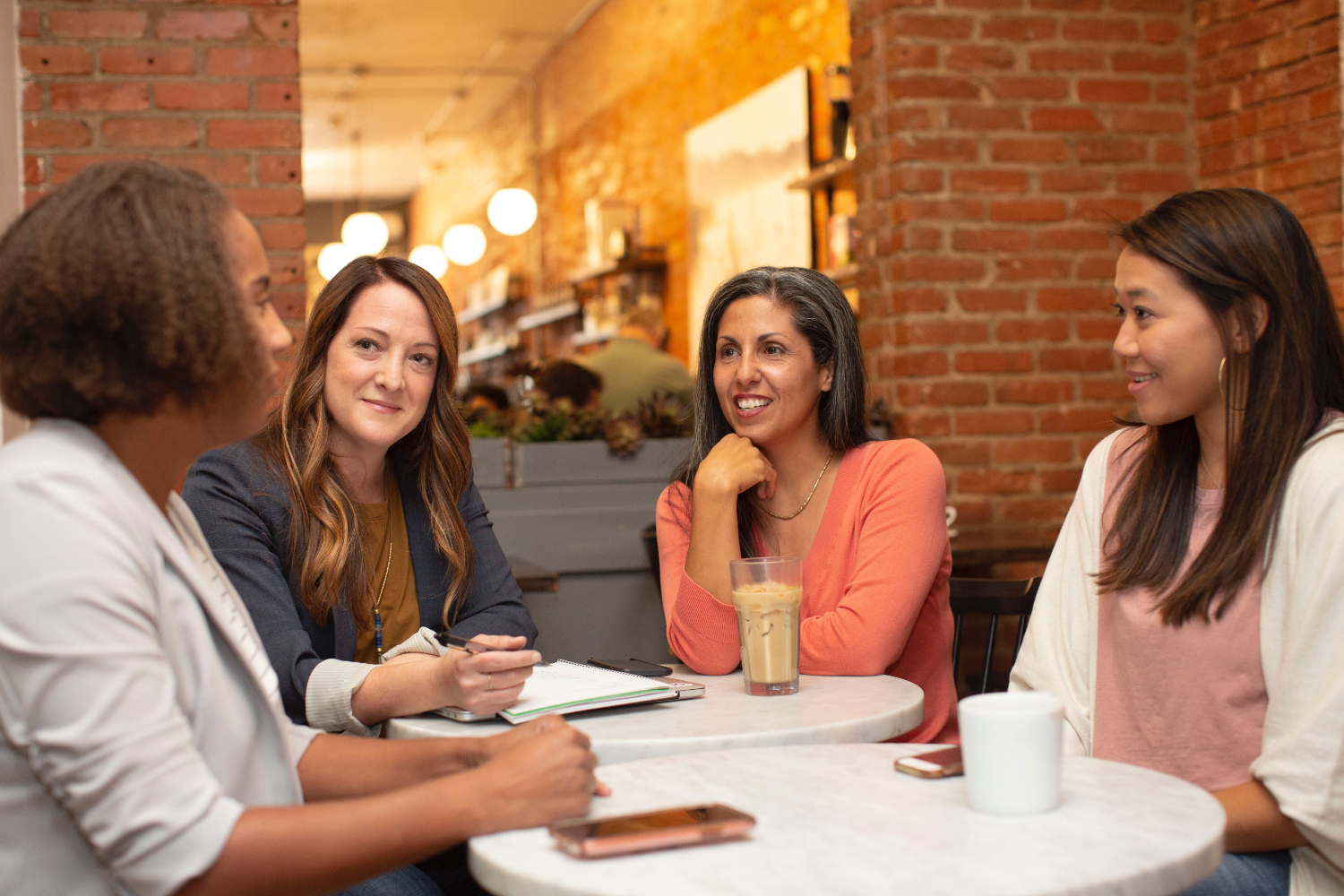 image of women sitting around a table talking